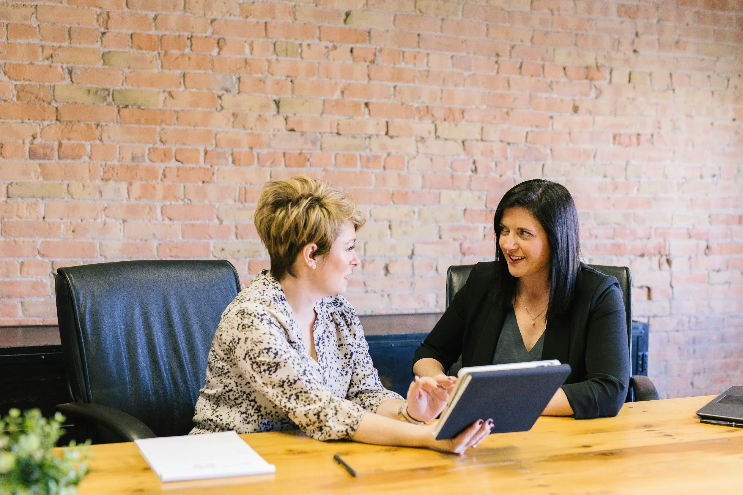 A speech-language pathologist working with a client on a laptop